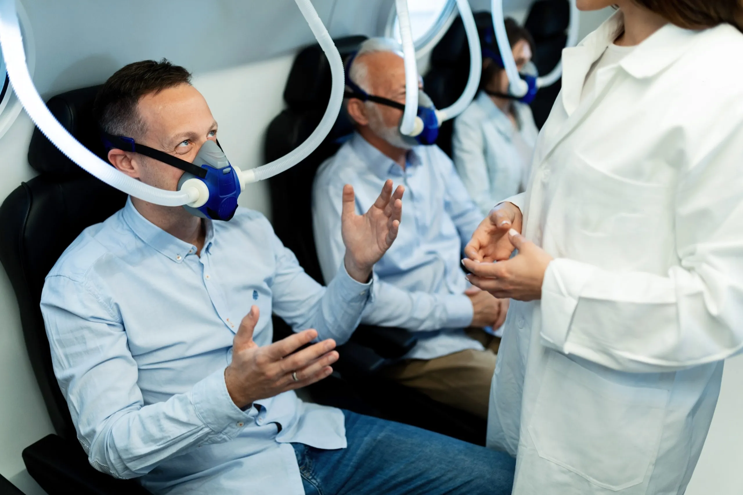 Home Sleep Testing in Australia Up 35% in 5 Years is Boosting CPAP Machine Adoption? happy-man-wearing-oxygen-mask-talking-female-doctor-hyperbaric-chamber-clinic-scaled