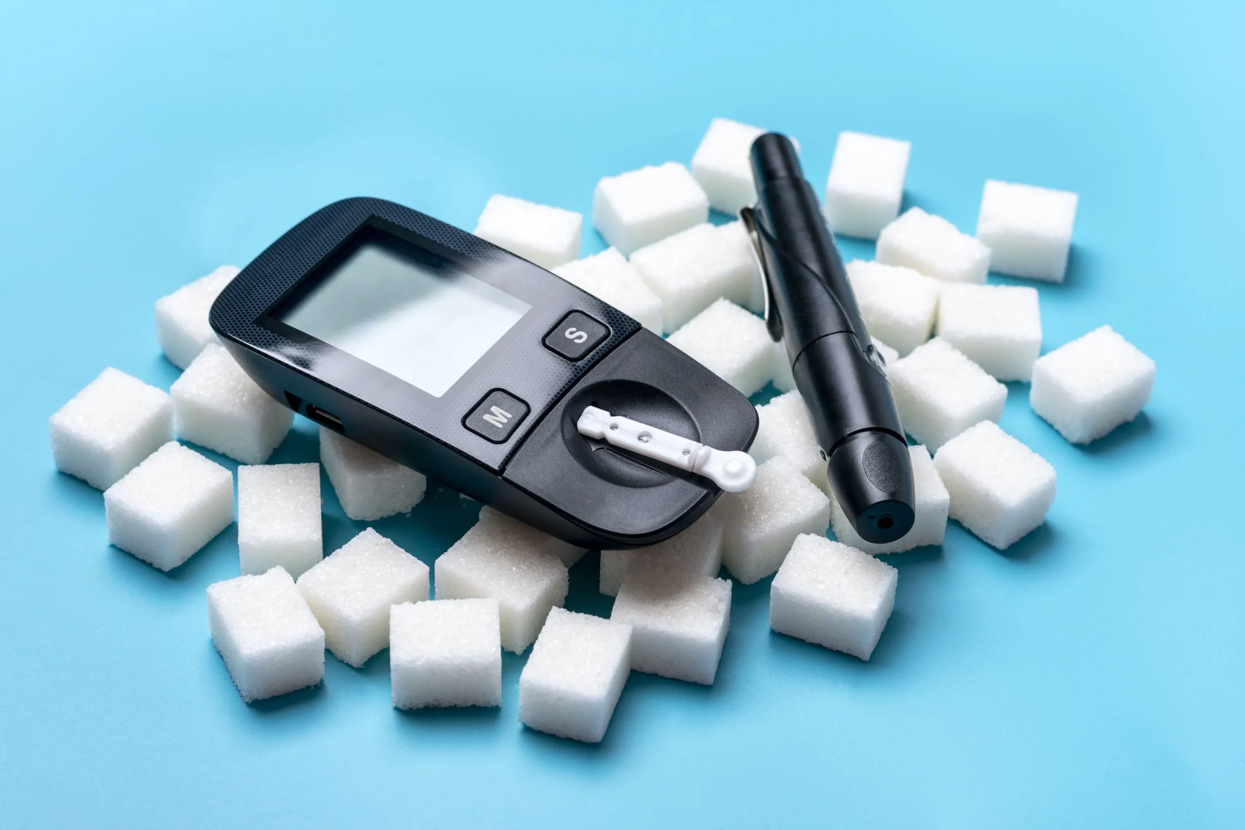 Indonesia Diabetes Care Devices Market Outlook 2030 glucometer-sugar-cubes-blue-background-high-blood-sugar-diabetes-concept-1-scaled