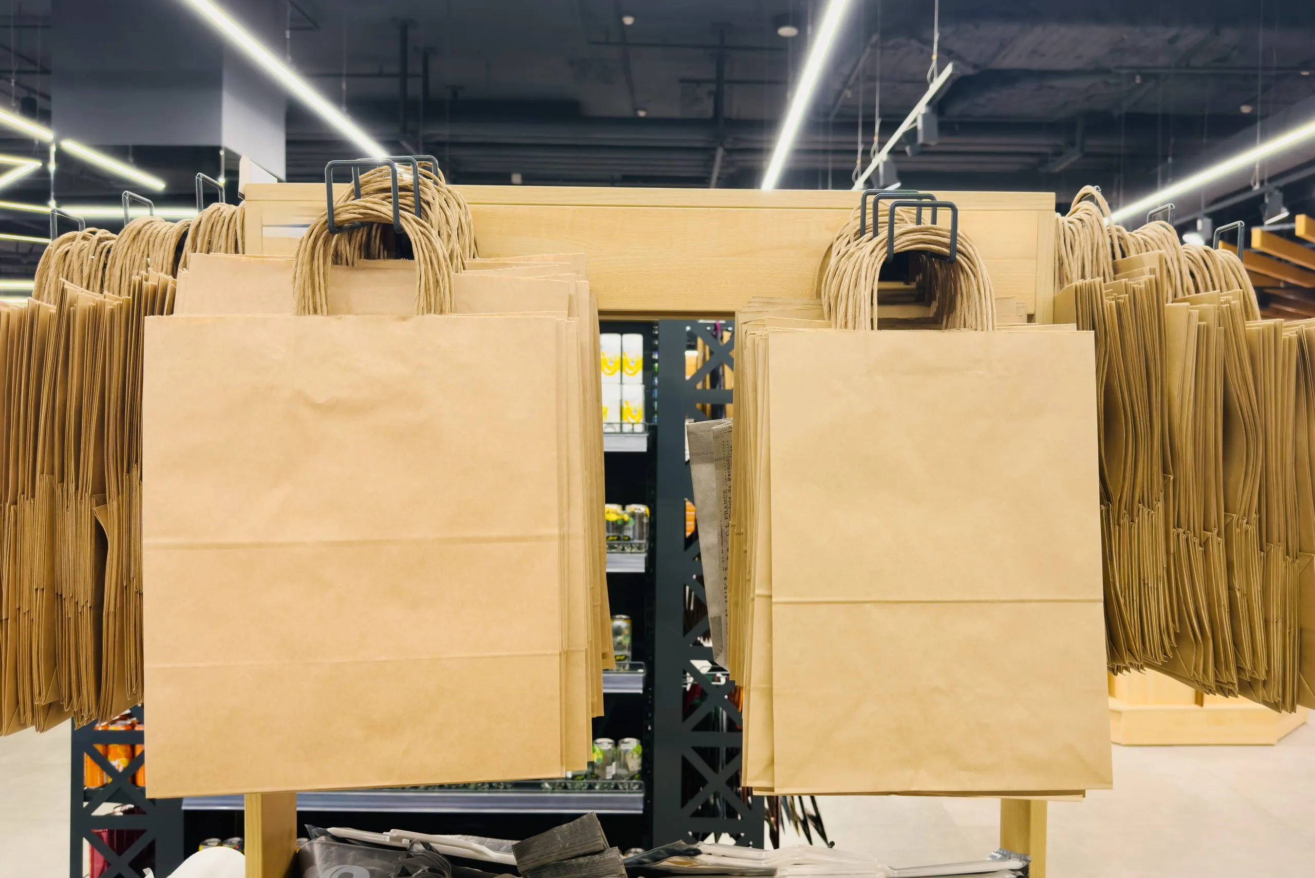USA Corrugated Packaging Market Outlook to 2030 row-empty-brown-paper-bags-hangs-hanger-store-1-scaled