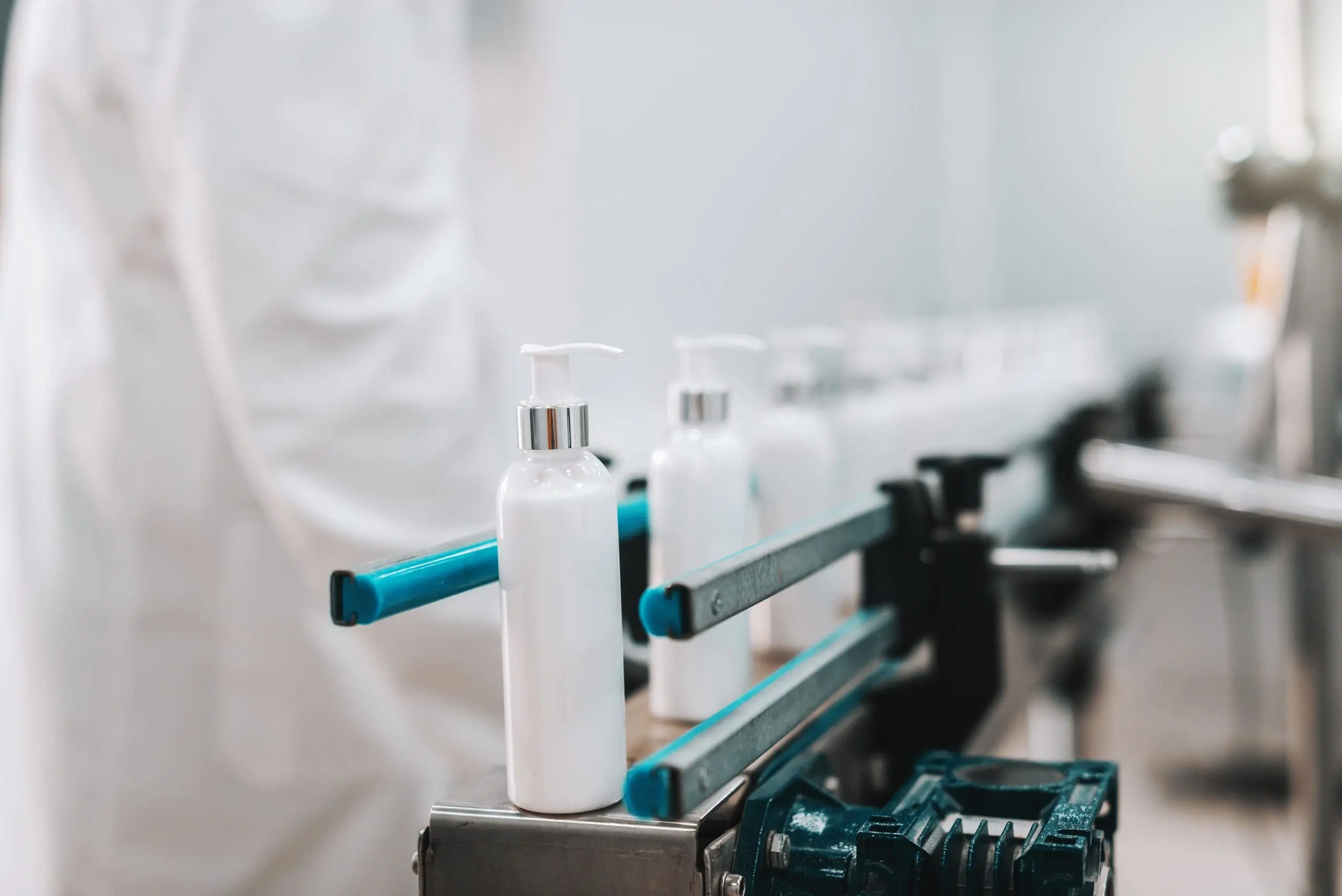 Business Model Development for Dispenser Manufacturing Company close-up-bottles-with-hair-conditioner-row-exit-pouring-machine-1-scaled