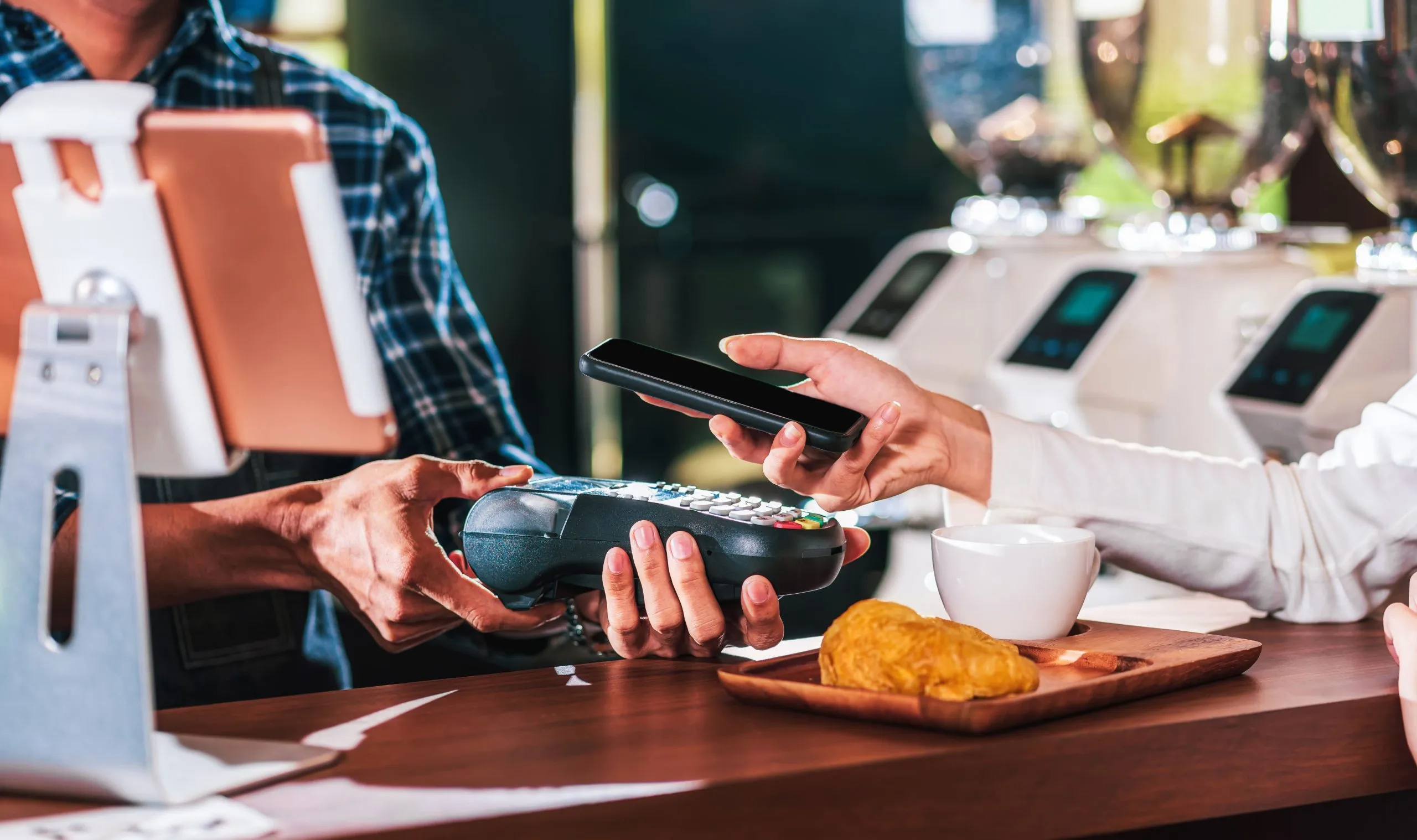 Enabling POS Lending Launch in KSA for Digital Finance International. closeup-asian-customer-man-hand-paying-money-via-contactless-channel-by-mobile-banking-application-1-scaled