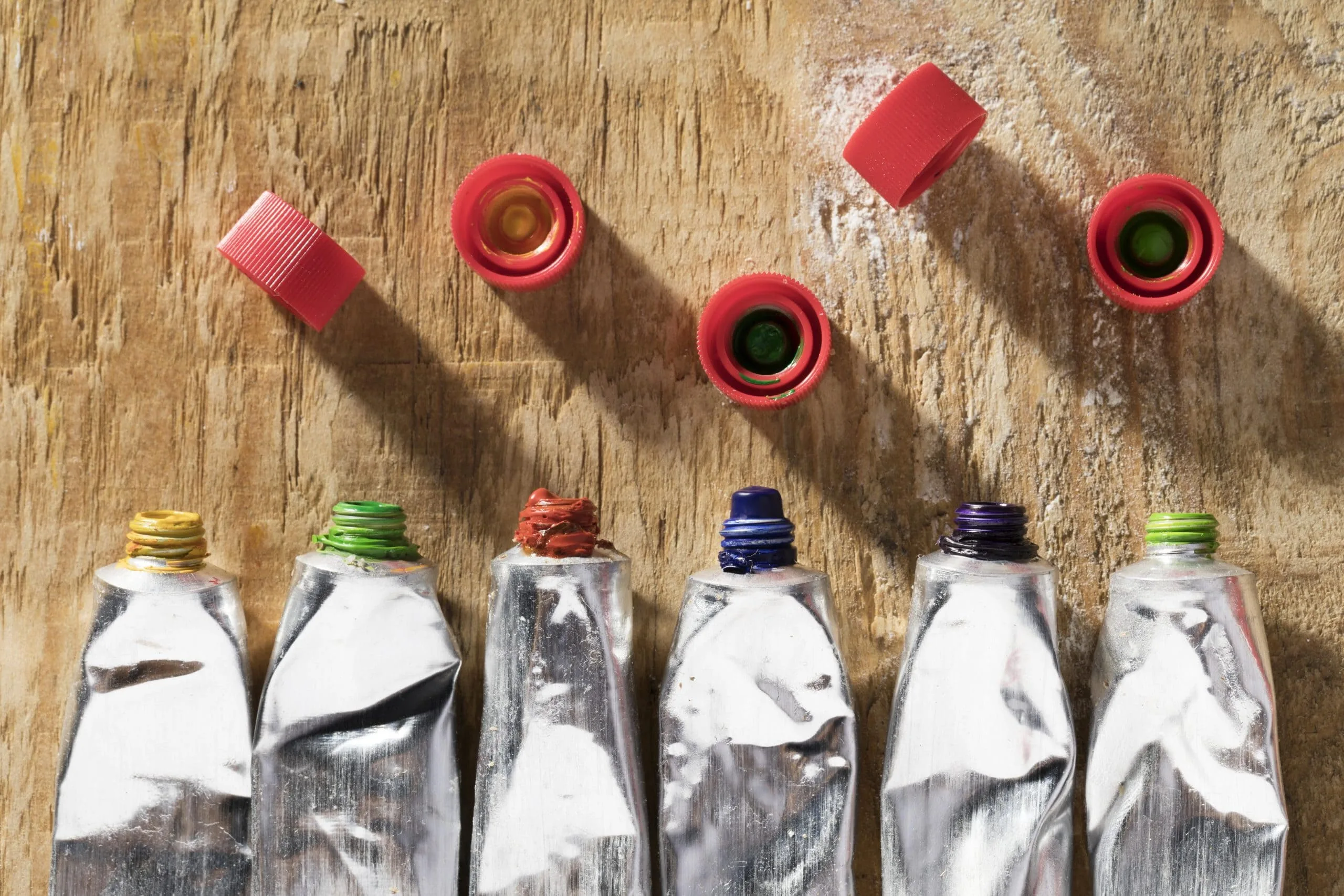 How the UAE’s 50 Billion Dollar Infrastructure Plan is Reshaping the Adhesives Market? top-view-paint-tubes-wooden-surface-scaled
