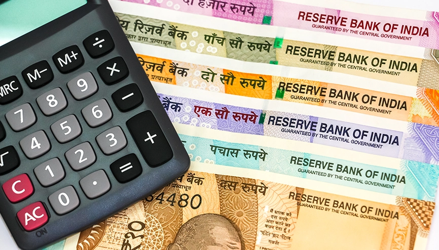 Indian rupee notes and calculator representing salary-related allowances and tax calculations under the Income Tax Act 2025